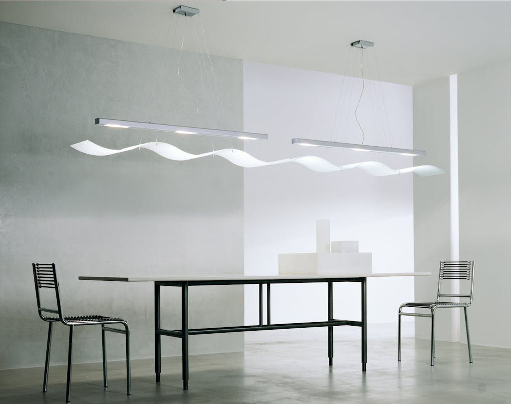 A contemporary minimalist room with sleek furniture, modern lighting, and clean design.